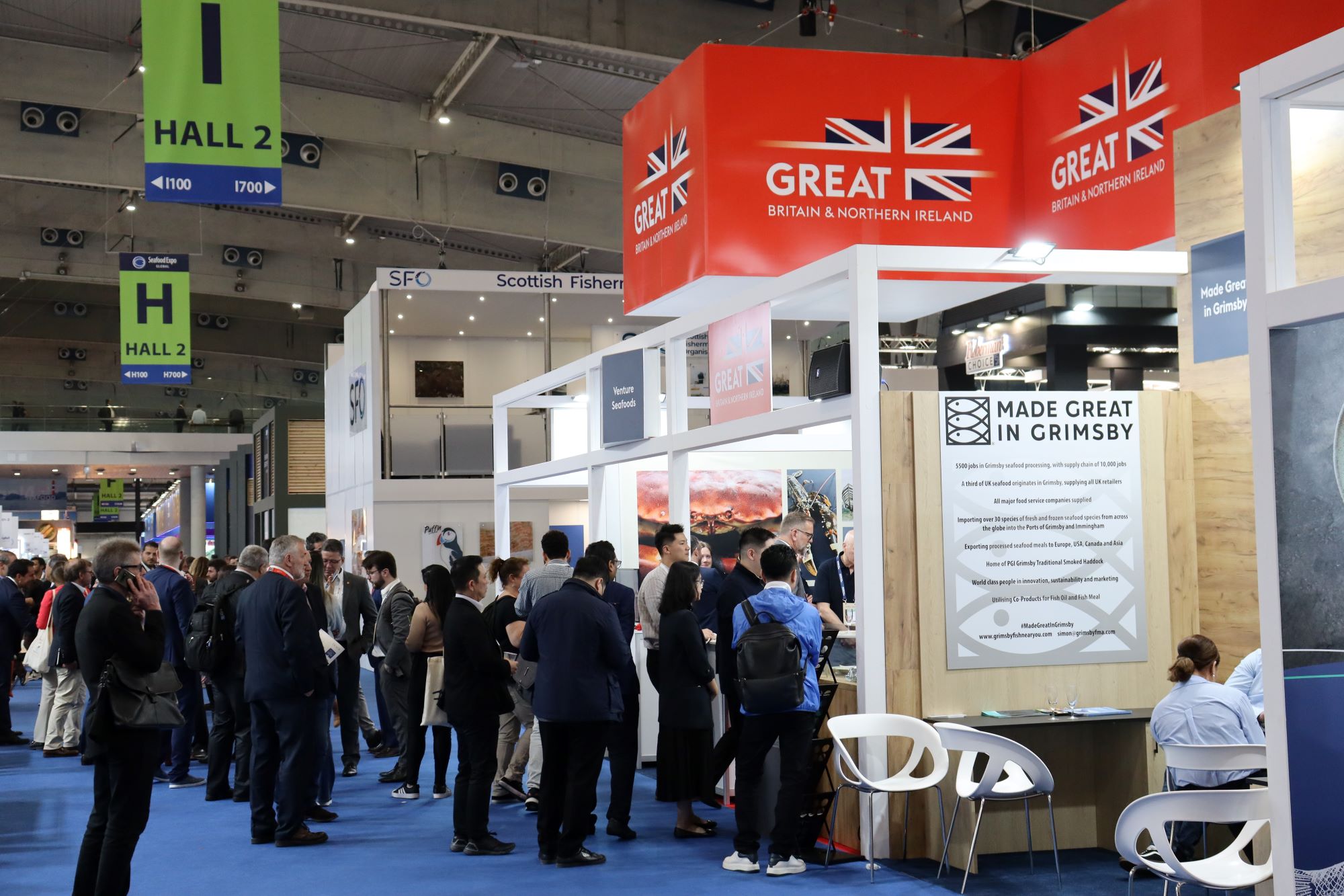 People standing at an exhibit at a trade show.