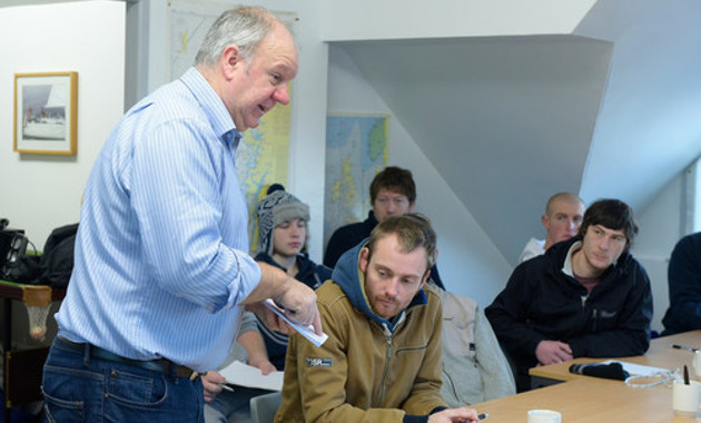 A group of fisherman in a classroom participating in onshore training