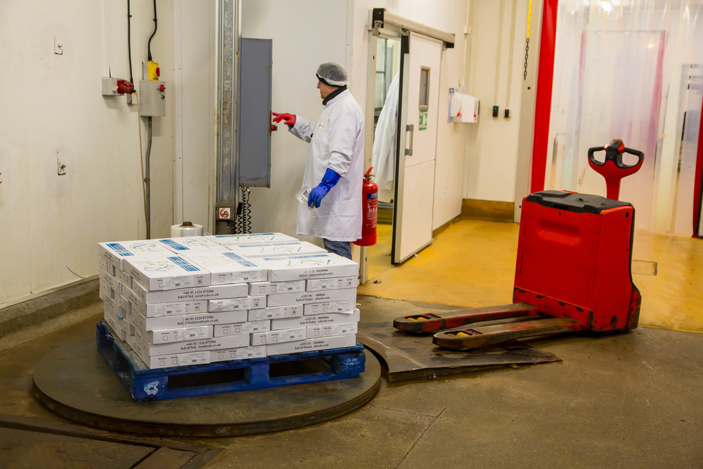 An employee operating a wrapping station