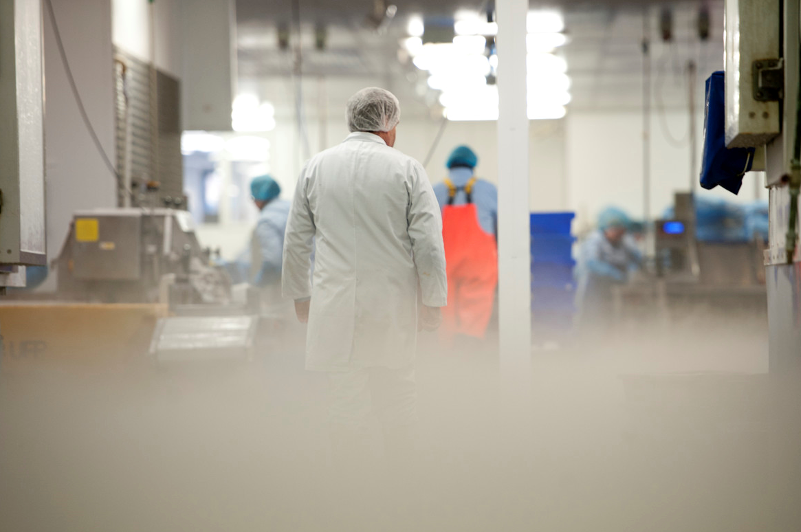 An employee walking down the factory floor