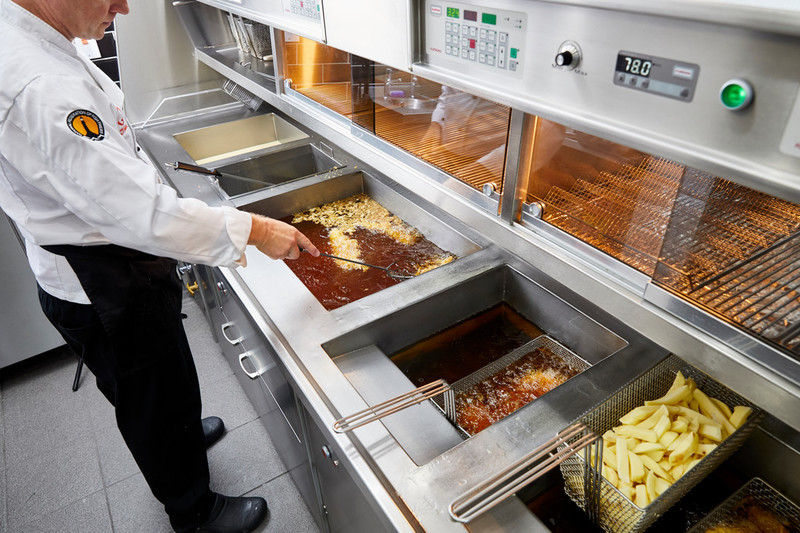 Employee frying fish